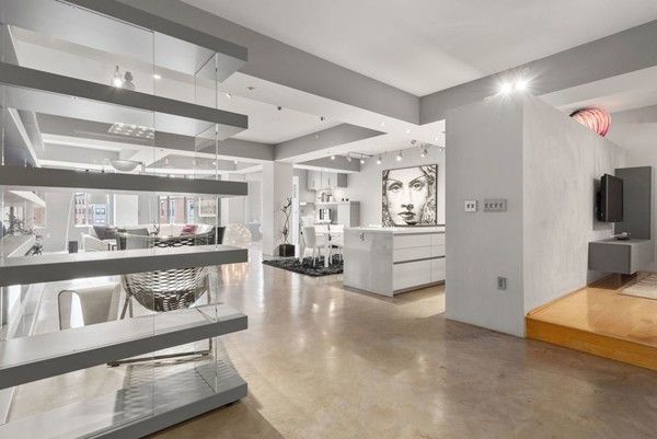 a kitchen with stainless steel appliances granite countertop a lot of counter space and wooden floor