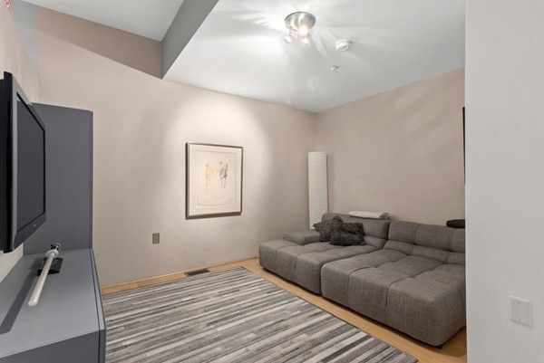 a bedroom with furniture and a flat screen tv