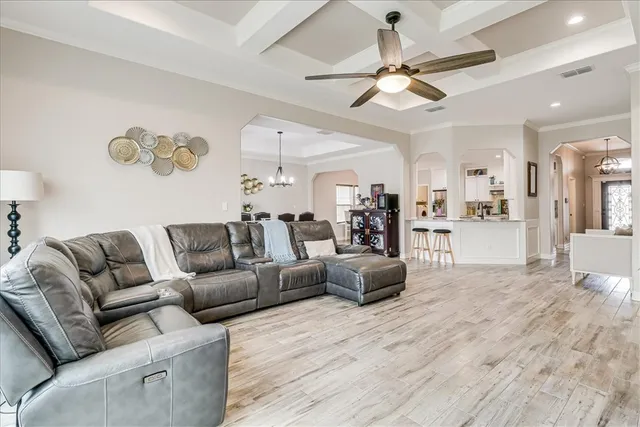a living room with furniture and kitchen view