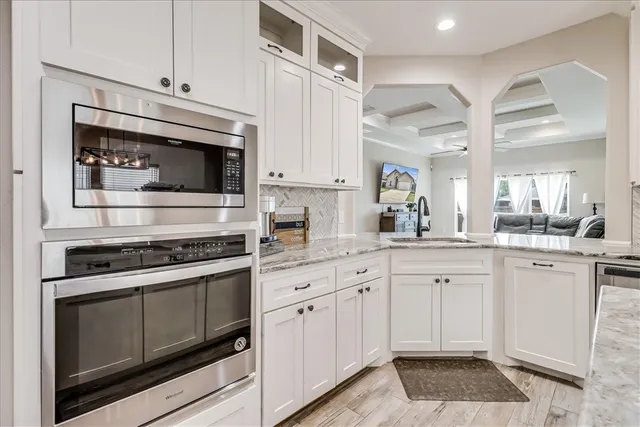 a kitchen with cabinets appliances and a counter