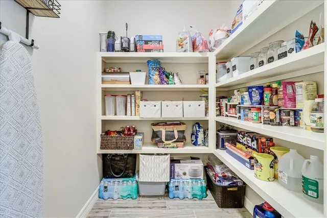 a room with fridge and a book shelf