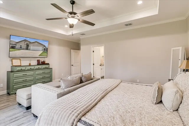 a bedroom with a bed and ceiling fan