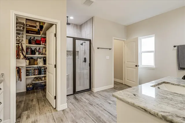 a view of a kitchen with refrigerator and wooden floor