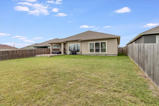 a view of a house with a yard and sitting area