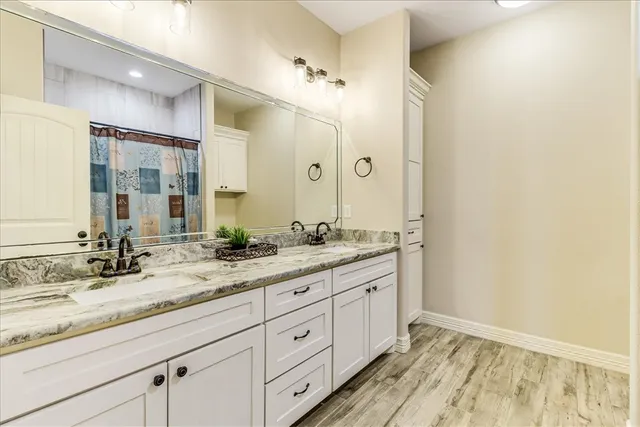 a bathroom with a granite countertop sink mirror and double