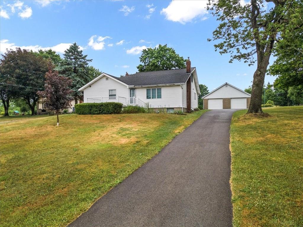 681 Herman Road Butler, PA 16002 - Photo 1 of 28 a front view of a house with a garden and yard