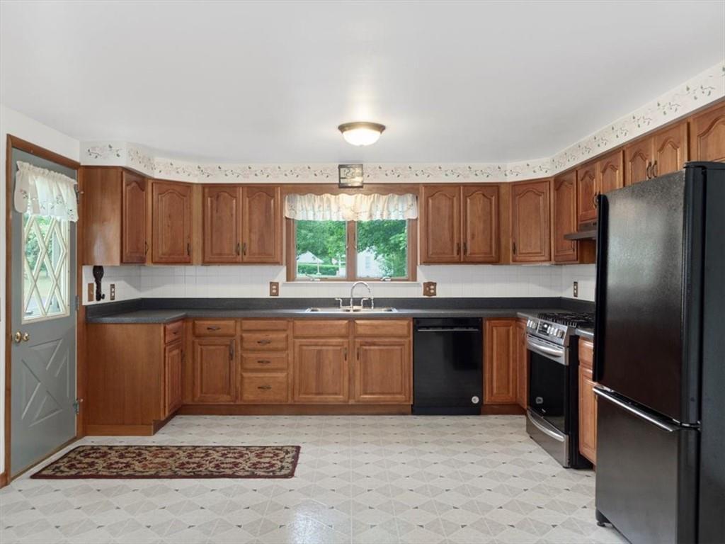 681 Herman Road Butler, PA 16002 - Photo 3 of 28 a kitchen with stainless steel appliances granite countertop a refrigerator stove top oven and sink
