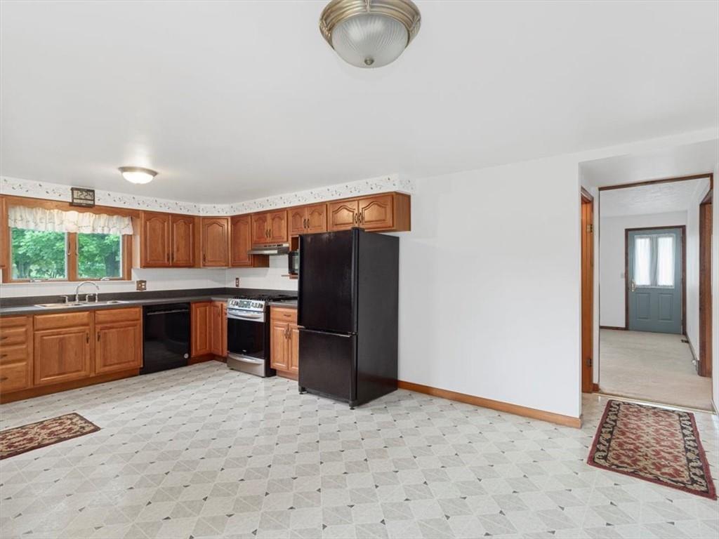 681 Herman Road Butler, PA 16002 - Photo 5 of 28 a kitchen with stainless steel appliances granite countertop a refrigerator and a sink
