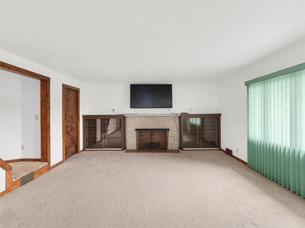 681 Herman Road Butler, PA 16002 - Photo 7 of 28 a view of a livingroom with a fireplace and window