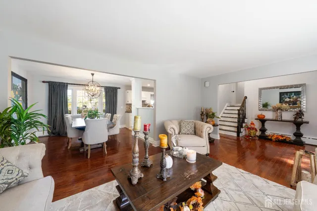 a living room with fireplace furniture and a potted plant