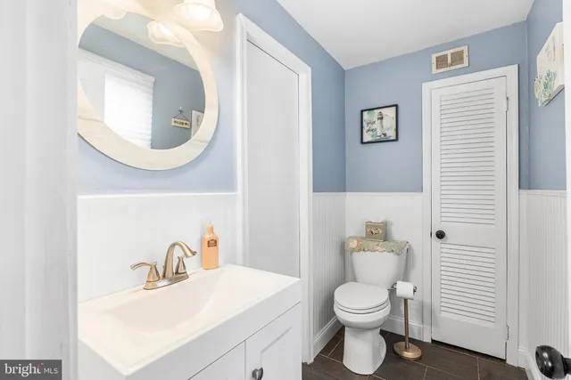 a bathroom with a sink vanity and a mirror