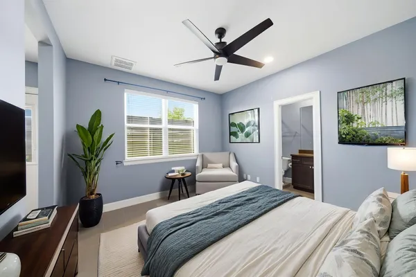 a bedroom with a large bed and a large window