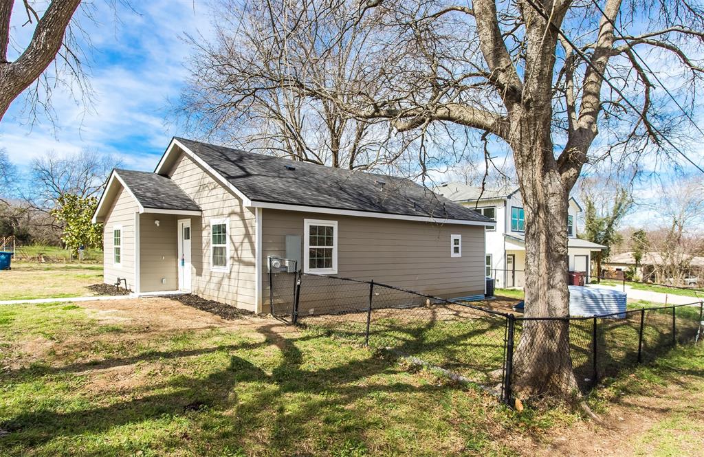 300 South 3rd Street Bonham, TX 75418 - Photo 13 of 14 a view of a house with a yard covered with snow and large trees