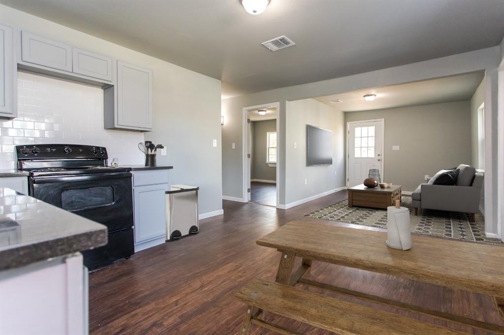 300 South 3rd Street Bonham, TX 75418 - Photo 2 of 14 a kitchen with a stove and a refrigerator