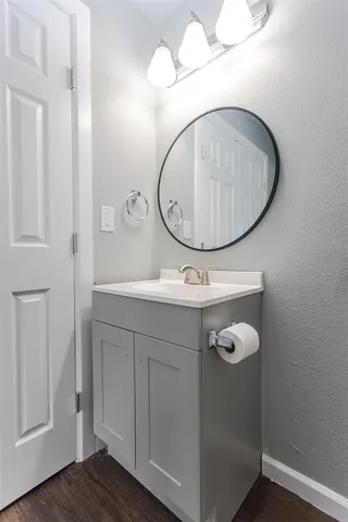 a bathroom with a sink mirror and vanity