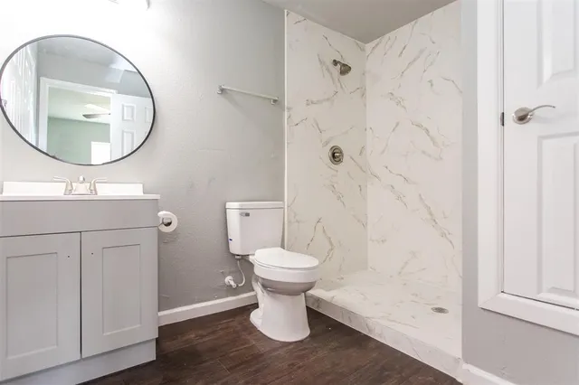 a bathroom with a toilet sink and a mirror
