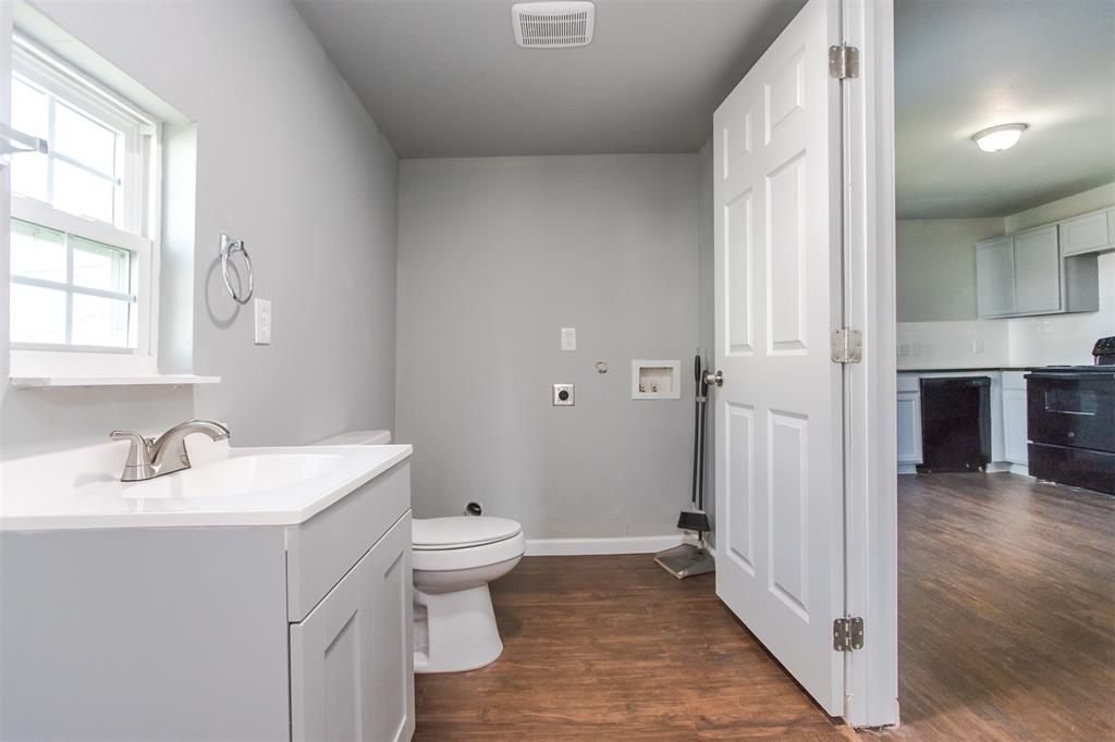 300 South 3rd Street Bonham, TX 75418 - Photo 6 of 14 a bathroom with a sink and a toilet