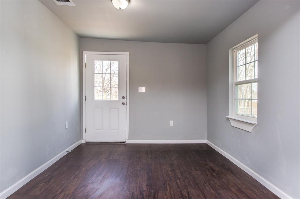 300 South 3rd Street Bonham, TX 75418 - Photo 8 of 14 an empty room with wooden floor and windows