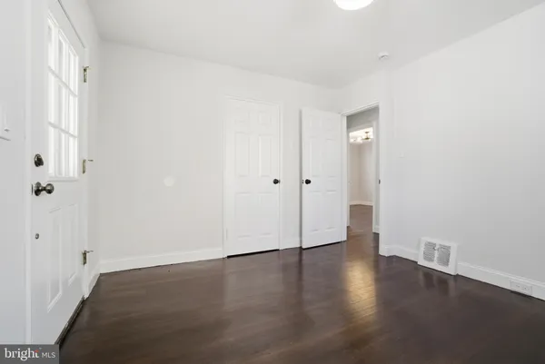 an empty room with wooden floor