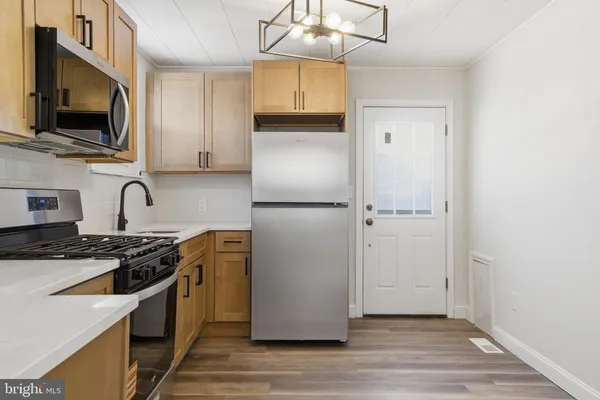 a kitchen with stainless steel appliances a refrigerator stove and sink