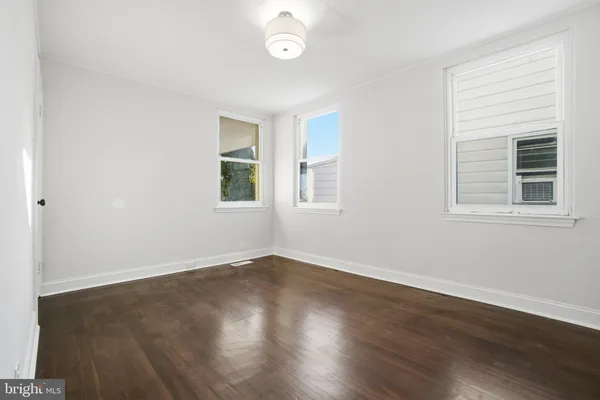 a view of a room with wooden floor and windows