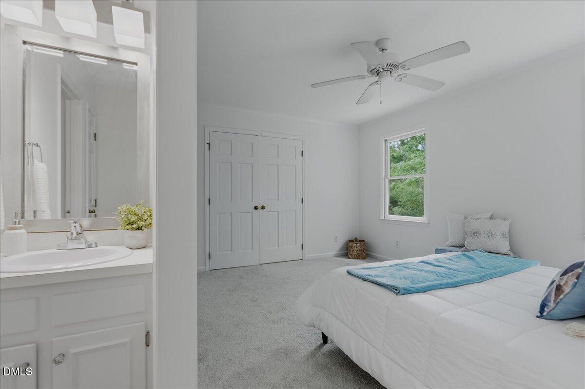 2834 Wayland Drive Raleigh, NC 27608 - Photo 15 of 26 a bedroom with a bed and a chandelier
