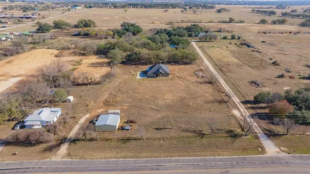 an aerial view of residential houses with outdoor space