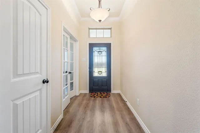 a view of a hallway view with wooden floor and staircase
