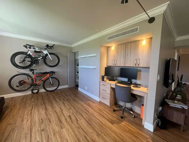 a view of a workspace with furniture and a window