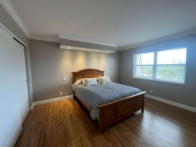 a bedroom with a bed and window