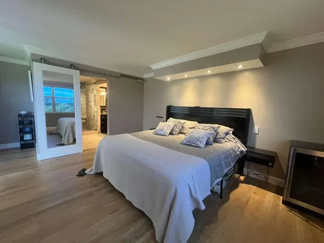 a bedroom with a bed and a television