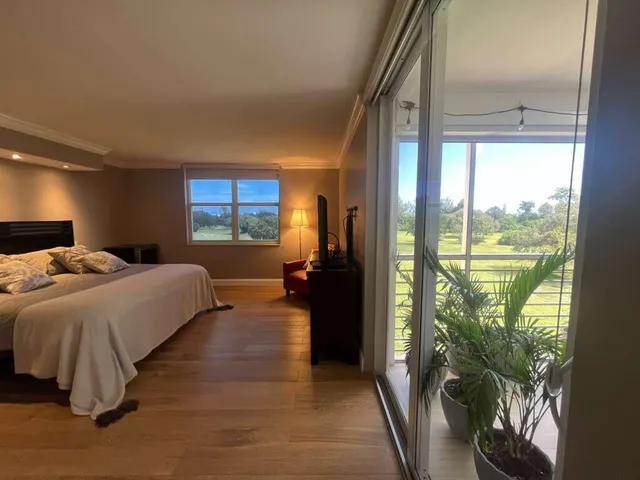 a bed room with a bed and a large window