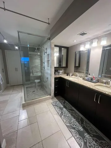 a bathroom with a sink a toilet and a shower