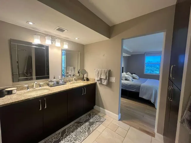 a en suite bathroom with a sink and mirror
