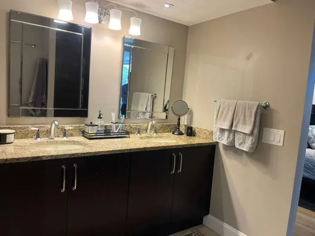 a bathroom with double sink and a mirror
