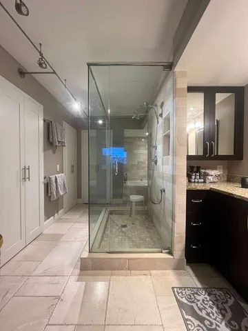 a bathroom with a glass door shower