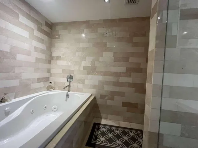 a bathroom with a bathtub and a shower