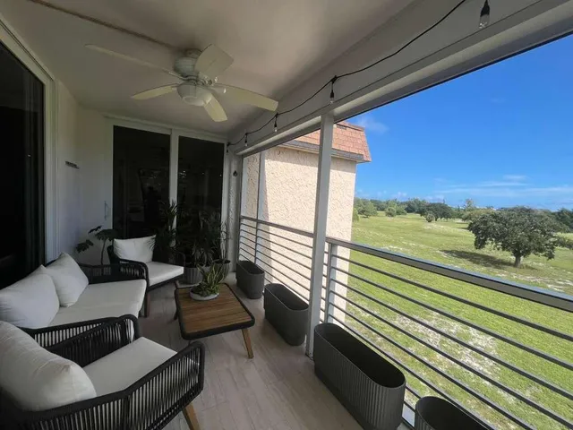 a balcony with furniture and a potted plant