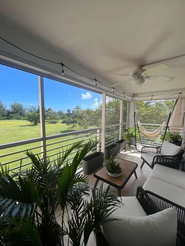 a living room with furniture and floor to ceiling windows
