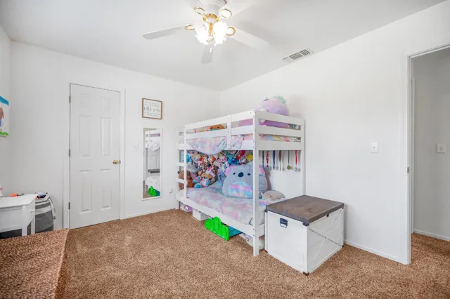 a bedroom with furniture and a wooden floor