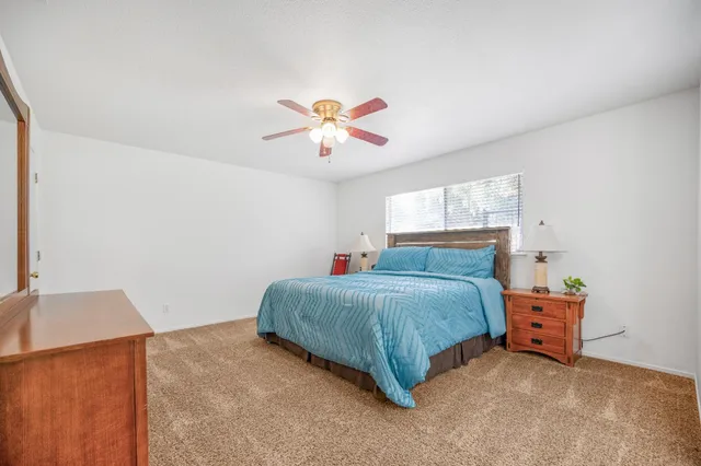 a living room with a bed and a chandelier