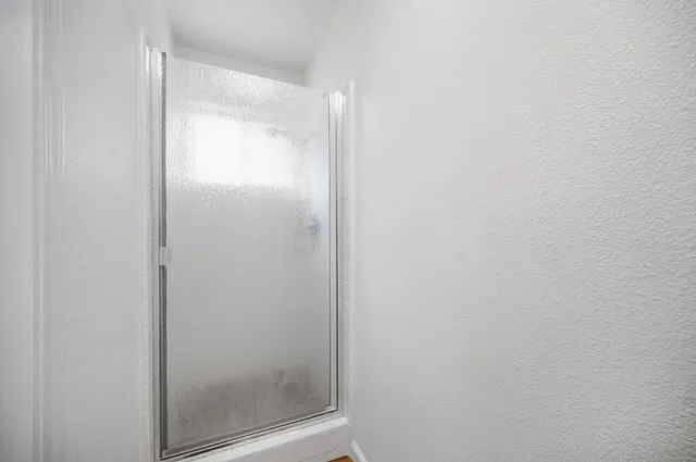 a bathroom with a glass shower door