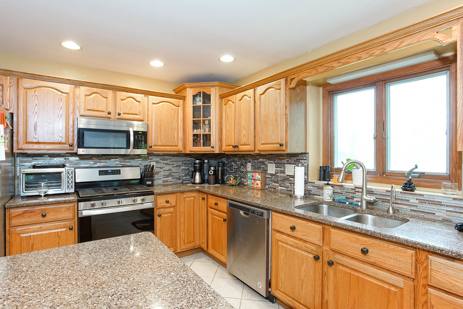 2394 Valley View Drive Kankakee, IL 60901 - Photo 19 of 73 a kitchen with stainless steel appliances granite countertop a stove sink and microwave