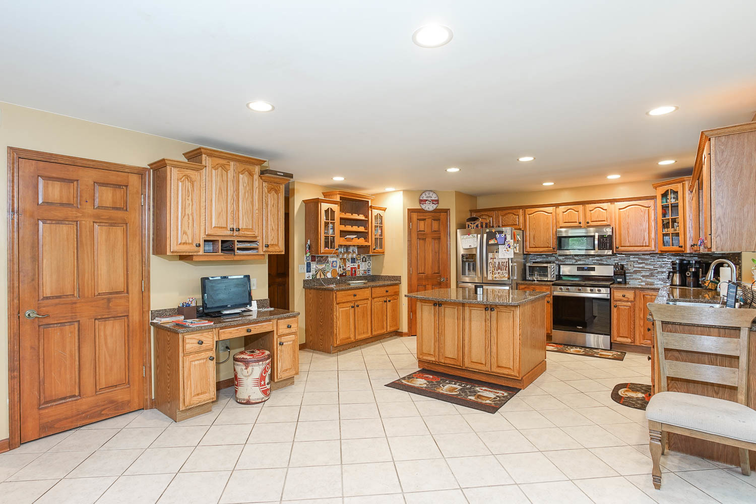 2394 Valley View Drive Kankakee, IL 60901 - Photo 22 of 73 a kitchen with stainless steel appliances kitchen island granite countertop a refrigerator and cabinets