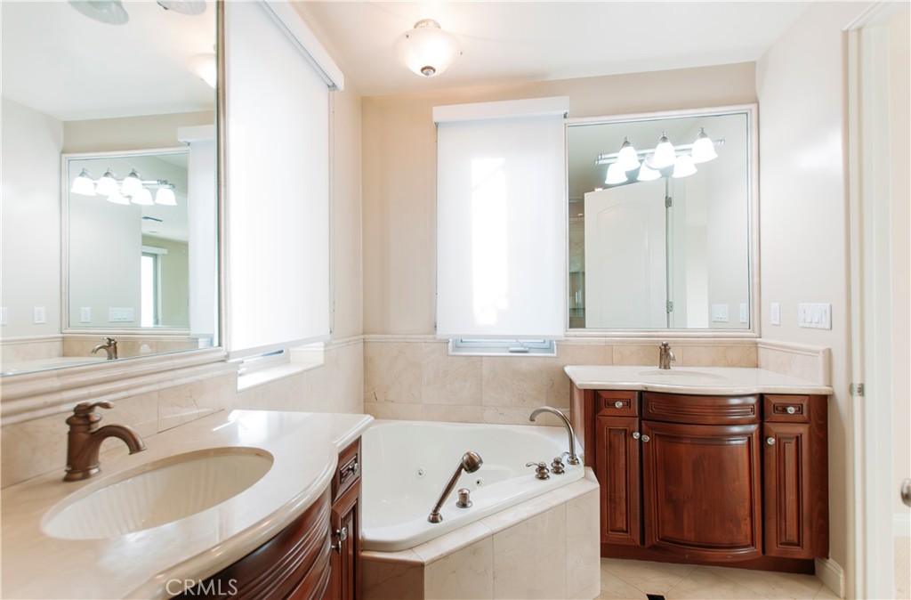 809 20th Street Hermosa Beach, CA 90254 - Photo 21 of 35 a bathroom with a granite countertop sink and a mirror