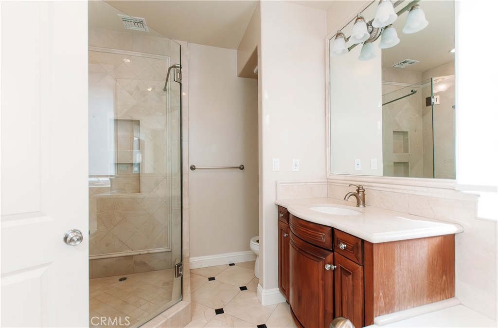 809 20th Street Hermosa Beach, CA 90254 - Photo 23 of 35 a bathroom with a sink vanity granite shower and a mirror