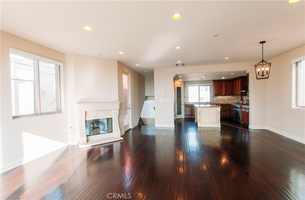 809 20th Street Hermosa Beach, CA 90254 - Photo 4 of 35 a view of an empty room and kitchen with wooden floor