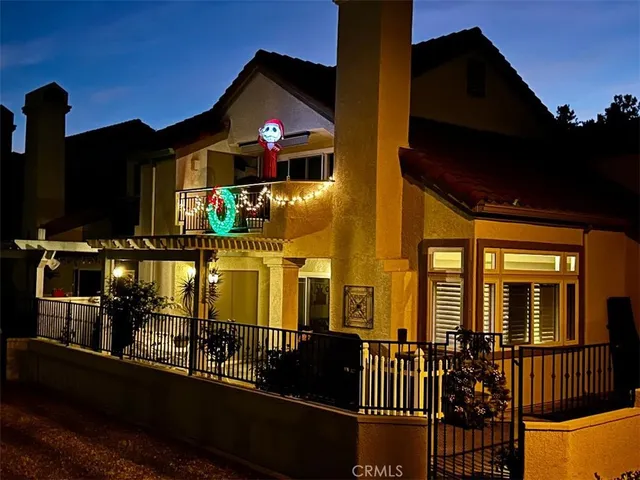 a front view of a house with swimming pool and lake view