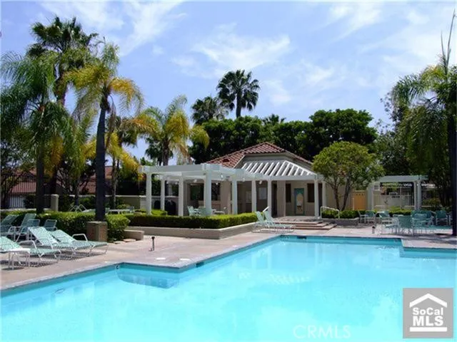 a view of a swimming pool with lounge chairs in patio