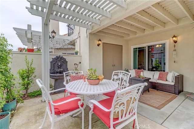a dining room with furniture and a potted plant